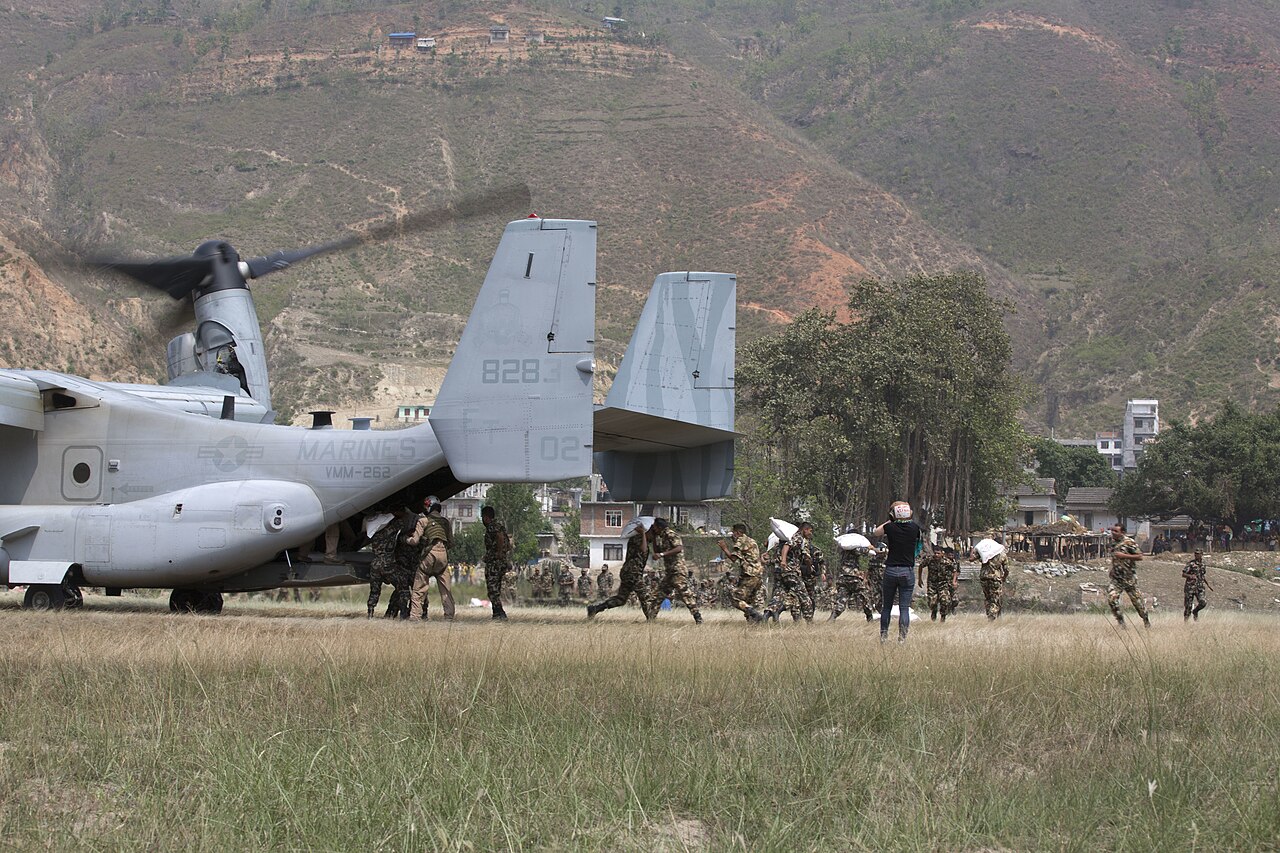 Nepalese personnel carry relief supplies from an aircraft in Manthali, Nepal.
